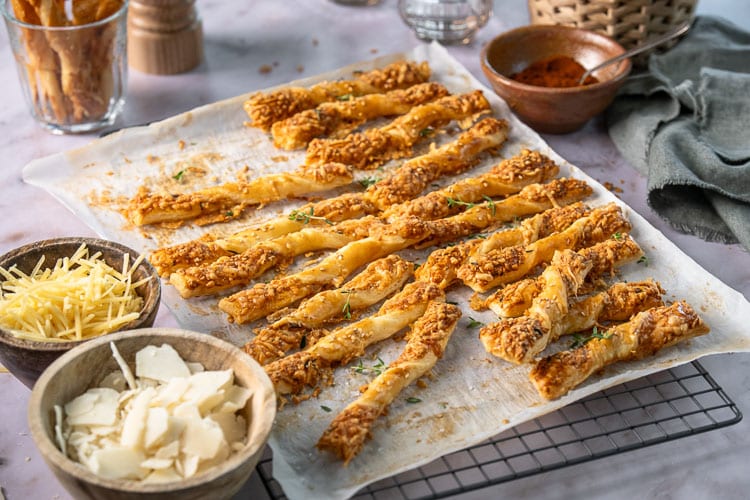 Kaasstengels maken van bladerdeeg: zelfgemaakte kaasstengels met oude kaas, Parmezaan en kruiden, krokant gebakken.