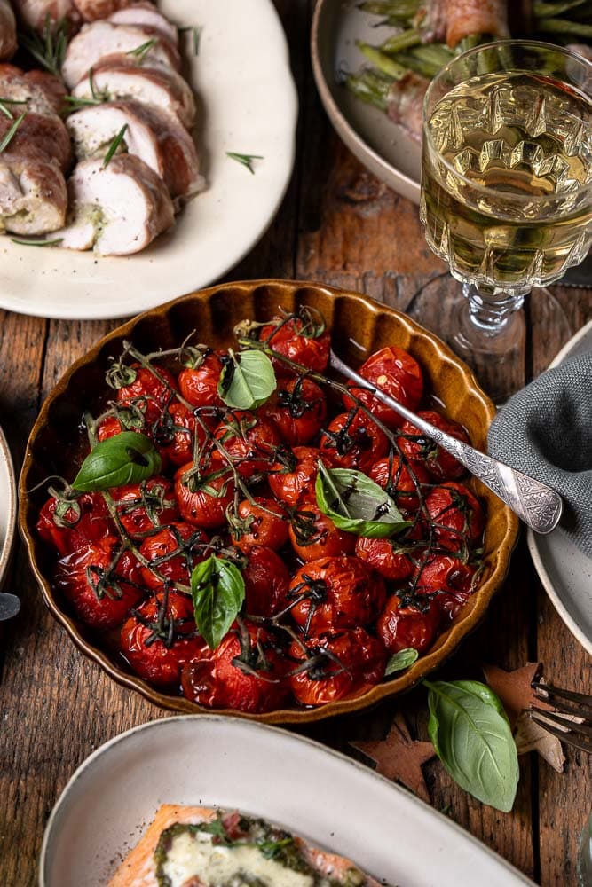 Geroosterde tomaatjes uit de oven met cherry tomaatjes, knoflook, olijfolie, balsamico en tijm. Makkelijk bijgerecht, zacht en vol smaak.